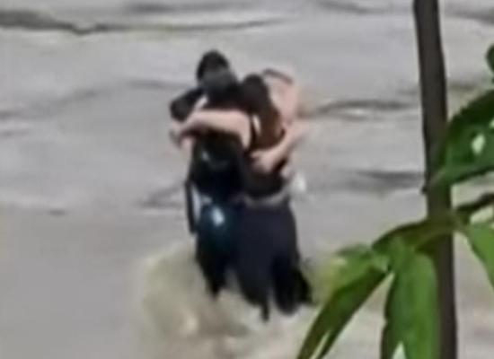 Friends seen in 'final embrace' before being swept away by flood