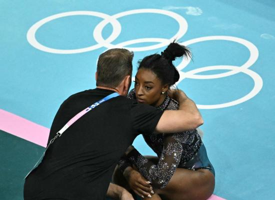 Biles powers through injury, dominates gymnastics qualifying