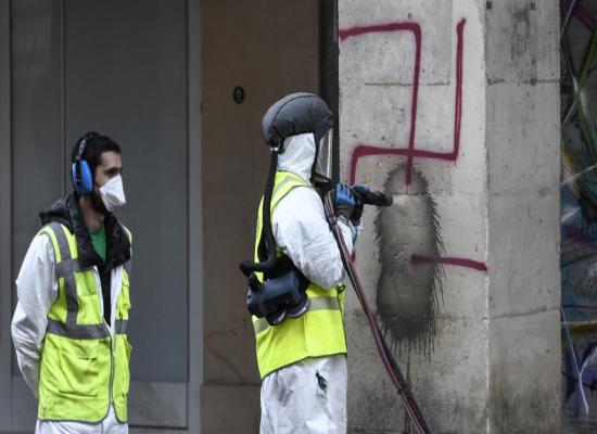 France charges two over Nazi swastika graffiti in Paris